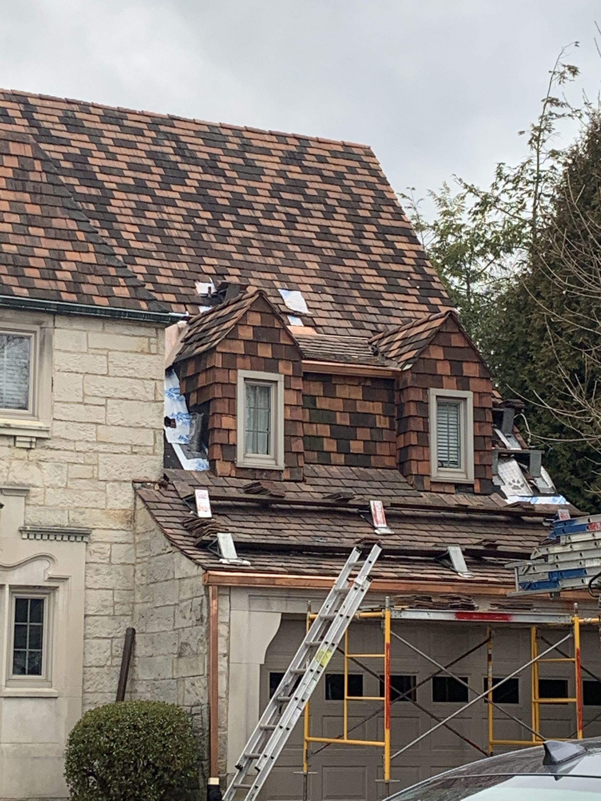 Tile roof repair in progress by RickJohn Roofing